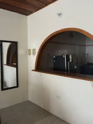 a room with a mirror on the wall and a counter at Apartamento La Matiz - Central in Mariquita