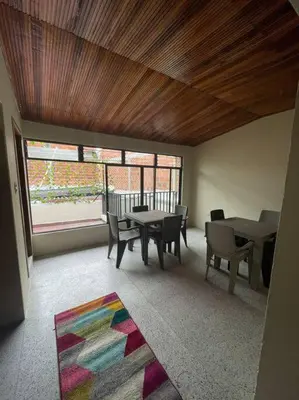 a room with a table and chairs and a large window at Apartamento La Matiz - Central in Mariquita