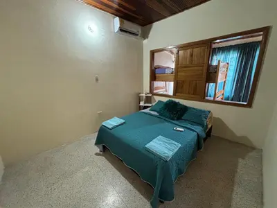 a small bedroom with a bed and a window at Apartamento La Matiz - Central in Mariquita