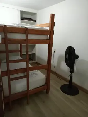 a room with a bunk bed and a fan at Estadio APARTE HOTEL 203 in Medellín