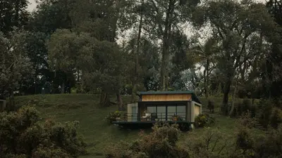 a tiny house in the middle of a field at La Pausa Hotelbistro in Guatapé