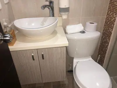a bathroom with a white sink and a toilet at 1009 Apartamento zona exclusiva Poblado in Medellín