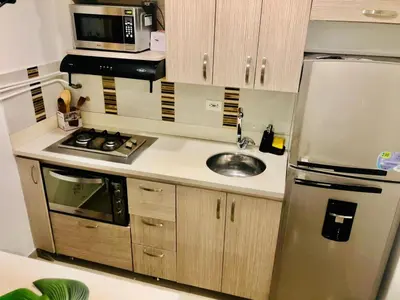a kitchen with a stainless steel refrigerator and a sink at 1009 Apartamento zona exclusiva Poblado in Medellín
