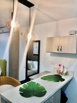 a kitchen with a counter with green leaves on it at 1009 Apartamento zona exclusiva Poblado in Medellín