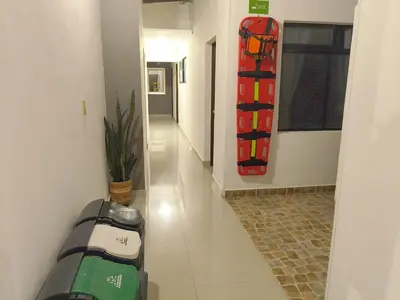 a hallway with a room with a skateboard on the wall at Hotel Palma De Sevilla Medellin in Medellín