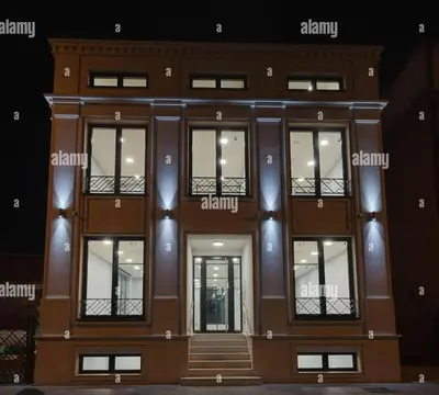 a brown building with glass windows and a door at apto in Medellín