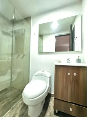 a bathroom with a toilet and a sink and a shower at 2104 Apartamento Poblado en la zona rosa de medellín in Medellín