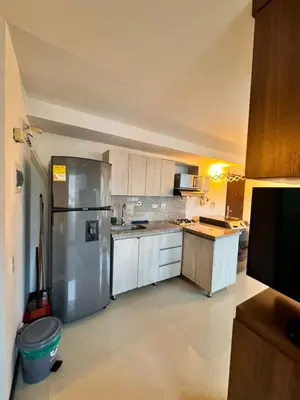 a large kitchen with a stainless steel refrigerator at 2104 Apartamento Poblado en la zona rosa de medellín in Medellín