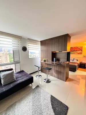 a living room with a couch and a table at 2104 Apartamento Poblado en la zona rosa de medellín in Medellín