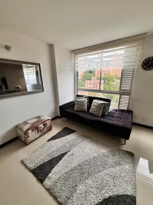 a living room with a couch and a large window at 2104 Apartamento Poblado en la zona rosa de medellín in Medellín