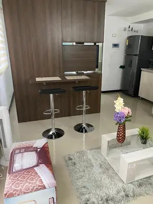 a living room with two bar stools and a counter at 2104 Apartamento Poblado en la zona rosa de medellín in Medellín