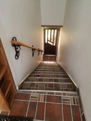a stairway with a rail on the wall and a door at Apartamento en Envigado in Envigado