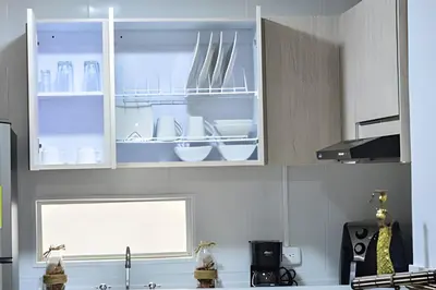 a kitchen with white cabinets with white dishes in it at Espectacular Apto Zona Rosa - Milán Estrato 5 in Manizales