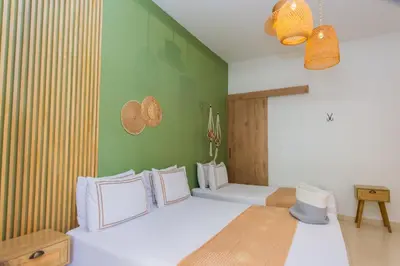 a living room with green walls and white floors at La Casona Hotel Boutique in Medellín