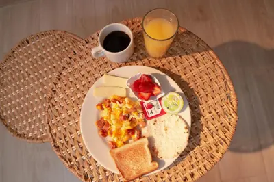 a plate of breakfast food on a wicker table at La Casona Hotel Boutique in Medellín