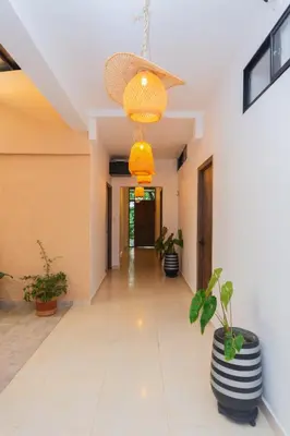 a hallway with potted plants and a ceiling at La Casona Hotel Boutique in Medellín