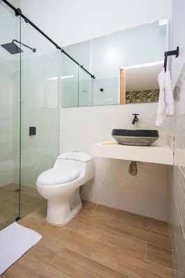 a bathroom with a toilet and a sink and a shower at La Casona Hotel Boutique in Medellín