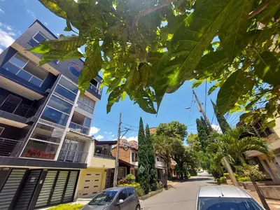 a city street with cars parked on the street at Apartamento Laureles la 33 in Medellín