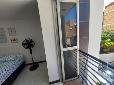 a room with a glass door leading to a balcony at Apartamento Laureles la 33 in Medellín