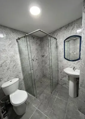 a bathroom with a shower and a toilet and a sink at Hotel Plaza Berlín in Medellín