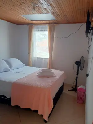 a bedroom with a bed and a window and a camera at Hotel El Balcon de madera in Norcasia