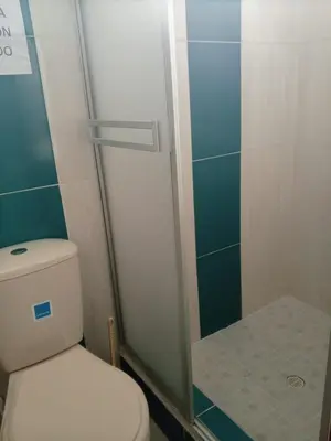 a bathroom with a toilet and a glass shower at Hotel El Balcon de madera in Norcasia