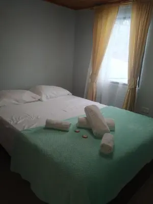 a bed with towels on it with a window at Hotel El Balcon de madera in Norcasia