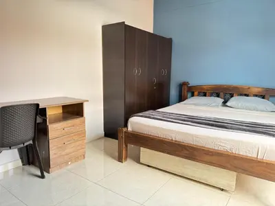 a bedroom with a bed and a desk and a chair at Apartamento Relax in Medellín