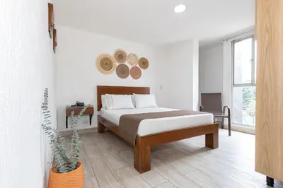 a bedroom with a bed and a potted plant at Hotel Prada in Bello