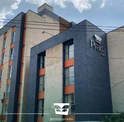 a building with a pizza hut sign on it at Hotel Prada in Bello