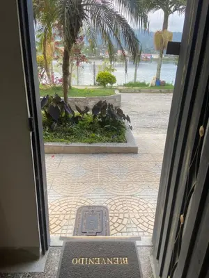 a door leading into a building with a sign on the ground at Apartamento con Vista y acceso al lago en Guatape in Guatapé