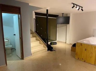 a bathroom with a staircase and a sink and a toilet at Cozy house en envigado con Jacuzzi in Envigado