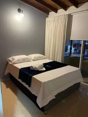 a bed sitting in a bedroom with a window at Cozy house en envigado con Jacuzzi in Envigado