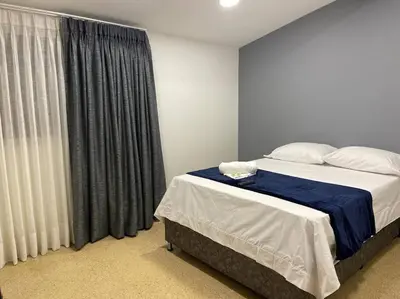 a bedroom with a bed and a large window at Cozy house en envigado con Jacuzzi in Envigado