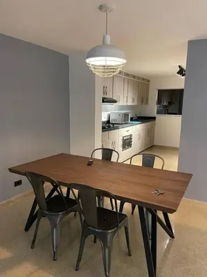 a wooden table and chairs in a room with a kitchen at Cozy house en envigado con Jacuzzi in Envigado