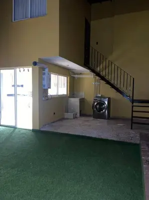 an empty room with a staircase and a washing machine at Cozy house en envigado con Jacuzzi in Envigado