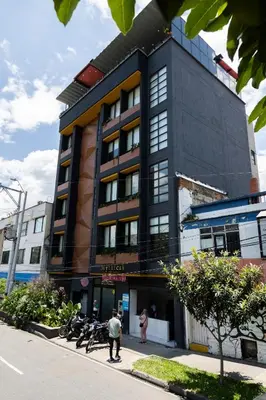 two people standing in front of a building at Mythical Hotel Boutique in Medellín