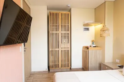 a hotel room with a bed and a door at Mythical Hotel Boutique in Medellín