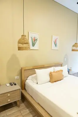 a bedroom with a large bed and a night stand at Mythical Hotel Boutique in Medellín