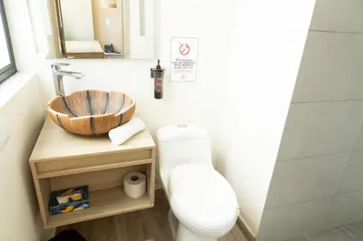 a bathroom with a toilet and a sink at Mythical Hotel Boutique in Medellín