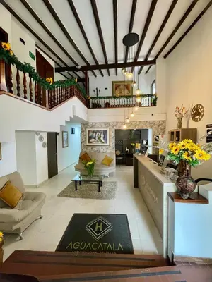 a living room with a couch and a table at Aguacatala Hotel Boutique in Medellín