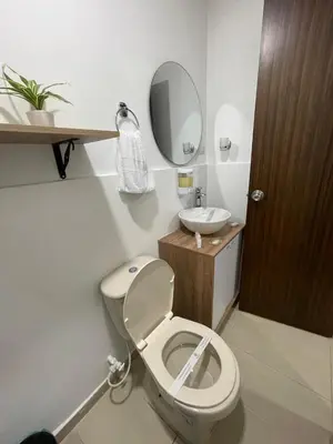 a bathroom with a toilet and a sink at Aguacatala Hotel Boutique in Medellín