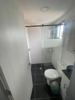 a small bathroom with a toilet and a shower at Duplex By Hope in Guatapé