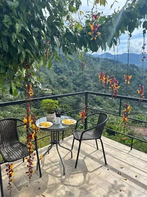a table and two chairs on a balcony with a view at Montecafé Jardín in Jardin