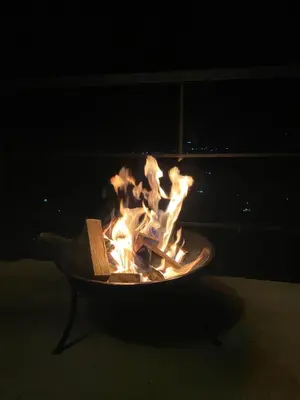 a fire pit with a book in it at night at Montecafé Jardín in Jardin
