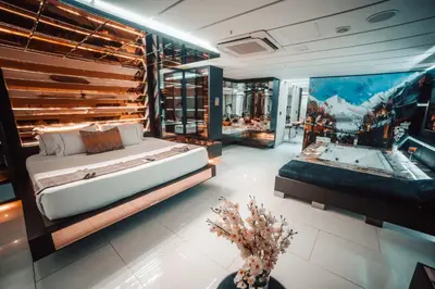 a bedroom with a large bed and a bath tub at 1Million Luxury Suites in Medellín
