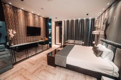 a hotel room with a bed and a television at 1Million Luxury Suites in Medellín