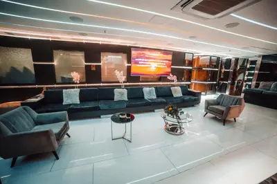 a living room with a couch and chairs and a tv at 1Million Luxury Suites in Medellín