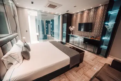 a bedroom with a large bed and a tv at 1Million Luxury Suites in Medellín
