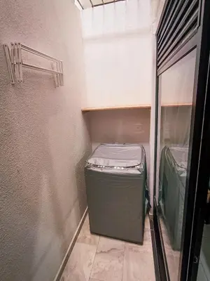 a small room with a small freezer in a trailer at Acogedor loft frente al tranvía in Medellín